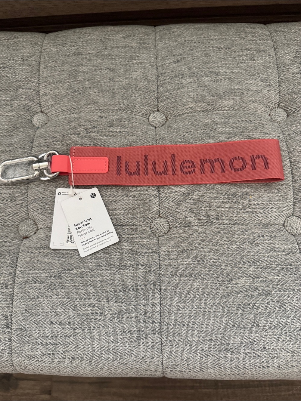 NWT, Lululemon “never lost key chain” in pinkish/ melon.